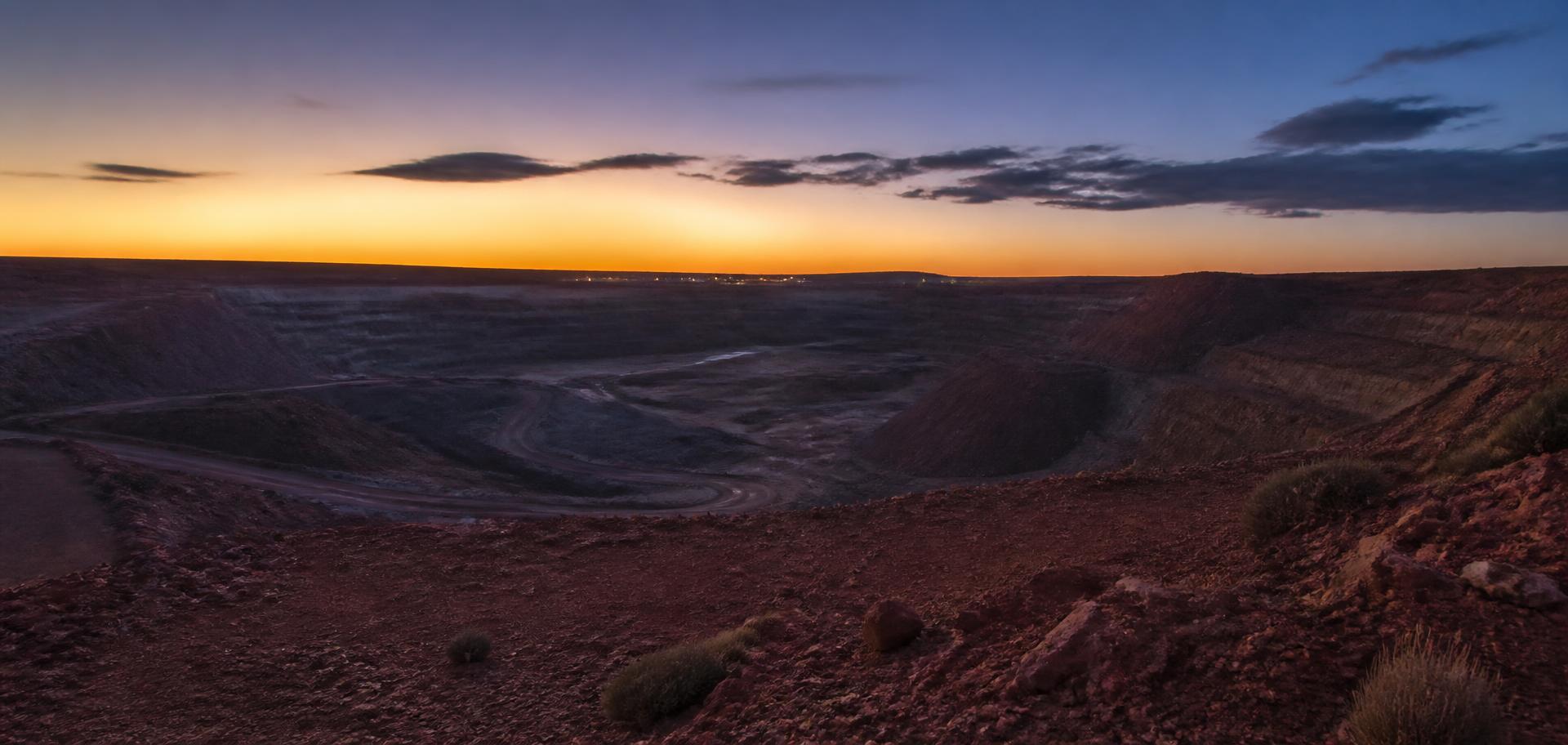Wide view of a quiet open-cut mine site at dusk in outback Western Australia