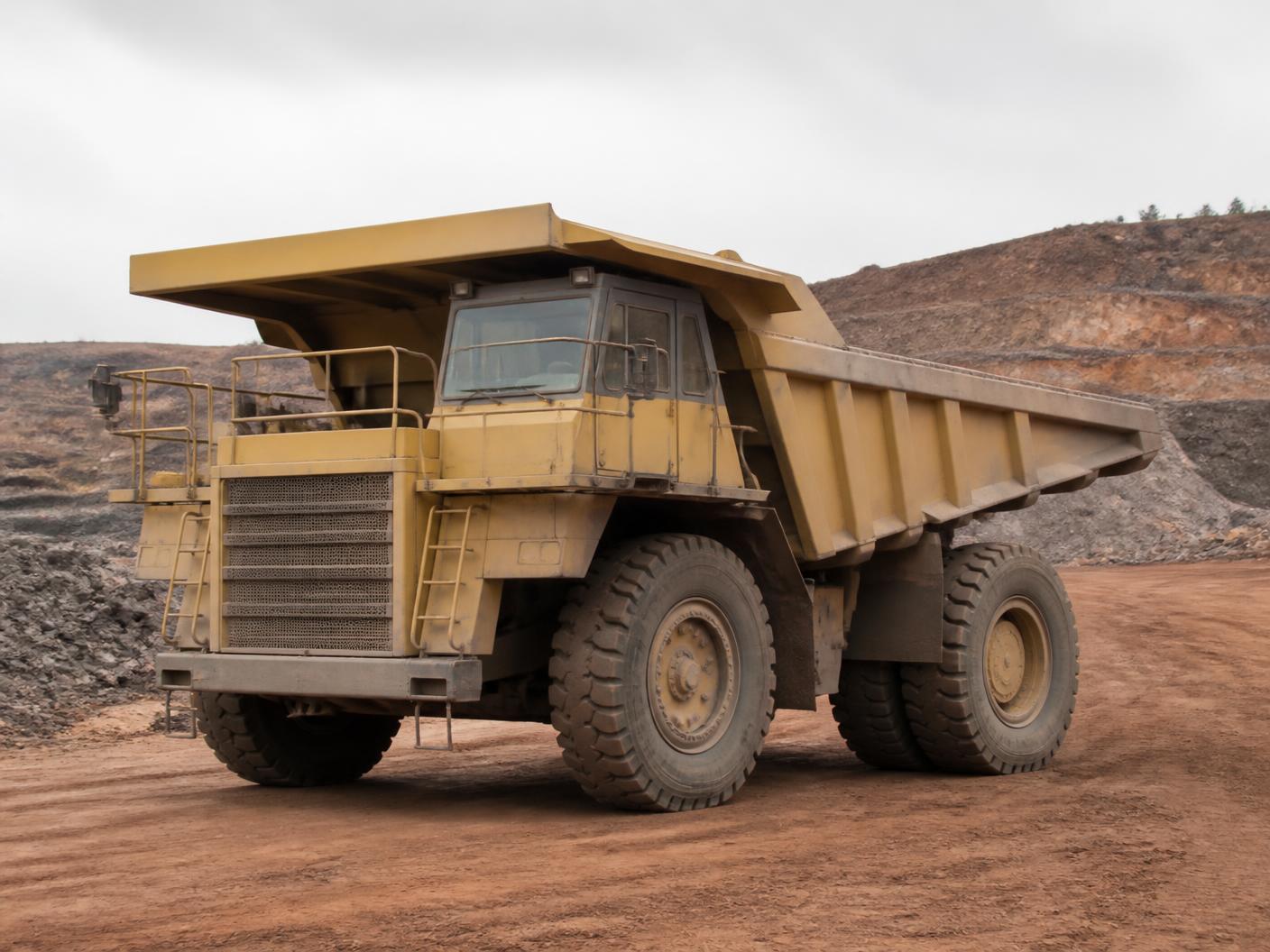 Unbranded mining haul truck parked on a red dirt haul road